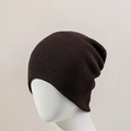 Detail of dark brown knitted beanie showing fine texture and elastic ribbing material - Coffee