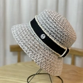Elegant woven straw bucket hat with pearl-trimmed black ribbon and M logo on display - 54-60cm Adjustable / Beige