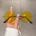 Detail showing vintage gold metal frames and clear yellow lenses of round sunglasses - Gold Frame Yellow Lenses