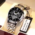 Detail view of Comudir automatic mechanical watch with black skeleton dial and silver band - Silver Steel Black Face