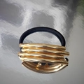 Minimalist U-shaped hair tie featuring five parallel golden metal tubes on a black elastic band - Gold Round Tube