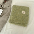 Soft green wool blend knit scarf with egg label on minimalist white background - egg Series / Light Green