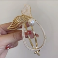 Elegant gold mermaid tail hair clip with white faux pearls and crystals on a smooth finish - Mermaid Tail Pearl Hair Clip