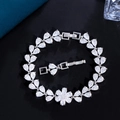 Elegant flower-shaped silver bracelet with pear-cut cubic zirconia on black background - White