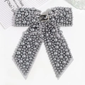 Macro shot of gray ribbon bow hair clip with faux pearls and rhinestone centerpiece - Gray