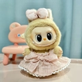 Labubu doll plush toy in yellow-brown fur wearing a pink plaid dress and matching bow - Milk Coffee-colored Skirt With Pendant / First And Second Generation Keychains Are Compatible With La Cloth Dolls. Dolls Not Included.