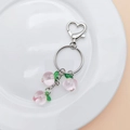 Sweet pink peach keychain with gold heart clasp and resin fruit charms on a white plate - Peach (With Keychain)