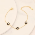 Macro detail of gold stainless steel bracelet featuring black flower charms and S-STEEL tag - 8# Black