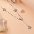 Elegant silver daisy necklace with five flower charms on a warm textured background - Steel Color Daisy Tassel Necklace (N611)