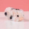 Realistic silicone pig toy with white fur and black spots on pink background - Mini Spotted Silicone Pig
