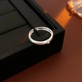 Detail of silver brushed texture ring with a small sparkling zircon on a black tray - Narrow Silver Open Ring