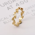 Golden 18k titanium steel leaf ring with polished finish on a white decorative card - US 6 / Gold