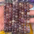 Macro view of natural purple phantom quartz beads with rich mineral inclusions - Natural Old Purple Ghost Phantom Quartz