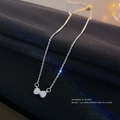 Elegant silver layered necklace featuring a sparkling crystal-studded bow pendant - Silver Tie Style
