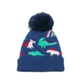 Close-up of knit texture featuring colorful dinosaur and unicorn patterns with blue pom-pom - M / Blue