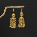 Detail of golden ethnic bell tassel earrings hanging on a natural dry wooden branch - E5949-1 Hollow Bead Bell Tassel