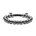 Close-up of a polished gunmetal bead bracelet with adjustable black braided cord - Hematite