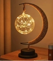 Close-up of decorative moon-shaped lamp with twine wrapped frame and glowing LED glass sphere - Hemp Rope Round Ball