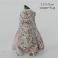 Resin animal figurine with white and pink spots and a small green bird ornament - Bear with Bird