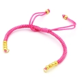 Handmade adjustable pink braided rope bracelet with decorative gold round beads on white background - Pink