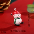 Macro shot of resin snowman pendant with dimensions 3.1cm height and 1.9cm width - Snowman with Red Hat and Green Scarf