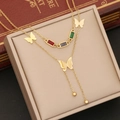 Gold double-layer butterfly necklace with colorful stones and beads on jewelry box - Double Layer Necklace / Gold
