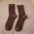 Dark brown cable knit crew socks with delicate lace trim for women on beige lace background - Crew Socks / Coffee