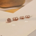 Detailed macro view of 925 sterling silver earring backs in rose gold flower and butterfly shapes - 4mm / Rose Gold