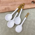 Set of 4 white ceramic spoons with gold handles and hanging holes on a wooden board - Gold Plated Japanese Soup Spoon 4Pcs