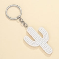 Detail shot of a handmade white beaded cactus keychain with silver metal ring and chain - White