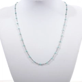 Detailed close-up of a stainless steel bead chain with turquoise enamel accents on a model - Silver + Pine Green