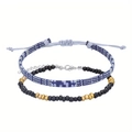 Set of two anklets featuring a blue-white braided rope and black beads with letter charms - Blue White Braided Rope And Black Bead Strand / Grey Blue