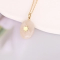 Close-up of pink natural stone pendant with gold starburst on stainless steel chain - Pink Oval Starburst (12#)
