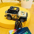 Detail of creative camouflage jeep keychain with durable metal ring on display stand - Khaki 3-Lamp Camouflage