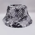 Detail of tropical palm leaf print on a reversible black and white bucket hat - Black White Tropical Leaves