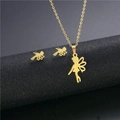 Detailed macro view of gold fairy pendant and stud earrings on black display stand - Gold