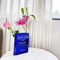Blue acrylic book-shaped flower vase with gradient finish and white typography print - Blue