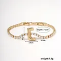 Gold finish tennis bracelet featuring a zircon-inlaid letter E pendant with dimensions - Letter J