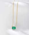 Detailed close-up of emerald-cut green gemstone on a delicate gold chain necklace - 925 Silver / Gold
