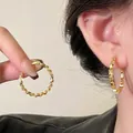 Golden twisted metal hoop earrings shown as pair and on ear in minimalist style - 106# Silver Needle-Gold (Real Gold Plated)