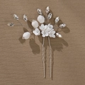 Close-up of handmade white ceramic flowers and sparkling rhinestones on bridal hair pin - HS-J5042 Single Silver Ceramic Flower Rhinestone Hair Pin