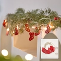 Christmas LED string lights featuring red hollow metal stockings with warm white glow - Iron Red Sock