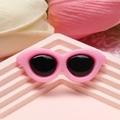 Close-up of a 4cm pink resin mini sunglasses accessory for DIY crafts and phone cases - Pink