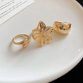 Detailed view of 3-piece gold-tone metal ring set featuring floral and geometric designs - Golden Flower Style (Set of 3)