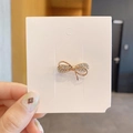 Golden bow brooch pin with sparkling rhinestones for women on white display card - Full Zirconia Bow