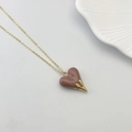 Elegant gold chain necklace featuring a dark pink heart pendant with gold claw setting - Brown