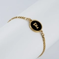 18K gold plated chain bracelet with black enamel oval pendant featuring golden letter F - Letter F / Gold/Black