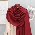 Close-up of lightweight burgundy cotton linen scarf draped over a beige blazer jacket - Burgundy