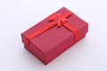 Elegant red rectangular jewelry gift box with a matching ribbon and bow decoration - Red Pendant Gift Box