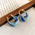 Elegante gedrehte Creolen mit blauem Emaille-Verlauf in warmer Goldoptik - Ohrenclip - Blauer Farbverlauf